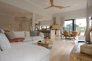 a living room with a white couch and a table at The Dunes in Island Beach