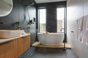 a bathroom with a large tub and a sink at The Dunes in Island Beach +40 photos