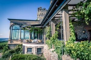 a house with a bunch of windows and vines at Burg & Gästehaus by Schwarzenstein in Geisenheim