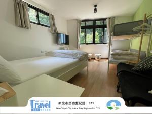 a small room with a bed and a bunk bed at Lucky House B&B in Jiufen
