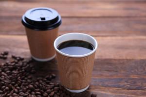 two cups of coffee on a table with coffee beans at Hotel Sincerity kani in Kani