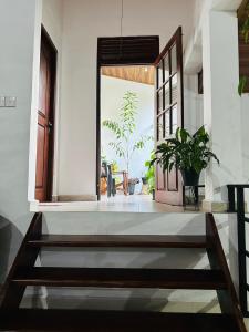a living room with a door and a table at Kandyan Gate Homestay in Kandy