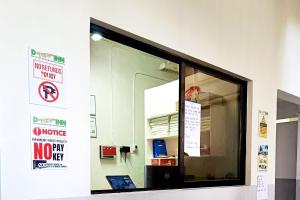 a window in a building with signs on it at D New Inn Mactan in Lapu Lapu City