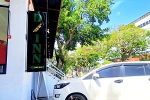 a white car parked next to a building at D New Inn Mactan in Lapu Lapu City