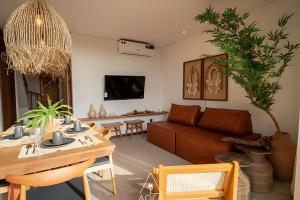 a living room with a table and a couch at Aluá Patacho in Pôrto de Pedras