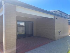 a brick building with a large open patio at Southern Retreat in Clyde North