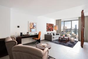 a living room with a desk and a room with a view at The First Collection Marina, Dubai, a Tribute Portfolio Hotel in Dubai