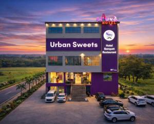 a hotel with cars parked in a parking lot at Truva Hotel in Faridabad