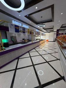 a shopping mall aisle with a sony store at Truva Hotel in Faridabad