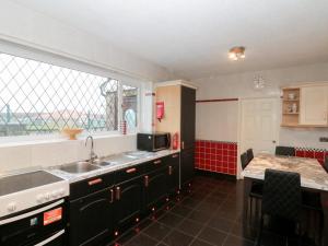 a kitchen with a sink and a microwave and a window at Seacrest Lodge in Scarborough +75 photos