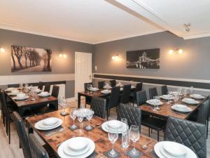 a dining room with long tables and chairs at Seacrest Lodge in Scarborough