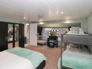 a bedroom with two bunk beds and a piano at Seacrest Lodge in Scarborough