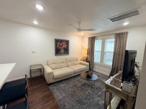 a living room with a couch and a tv at Quiet Private 1BR Apartment 10 mins to Med Center in Houston