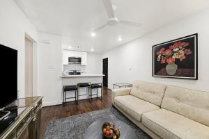 a living room with a couch and a kitchen at Quiet Private 1BR Apartment 10 mins to Med Center in Houston