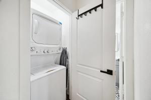 a white kitchen with a washer and dryer at Quiet Private 1BR Apartment 10 mins to Med Center in Houston