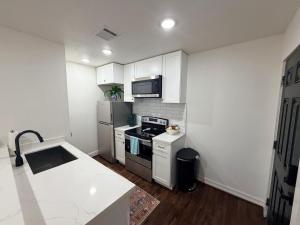 a small kitchen with a stove and a refrigerator at Quiet Private 1BR Apartment 10 mins to Med Center in Houston +8 photos