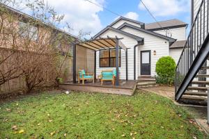 a tiny house with two blue chairs on a deck at Quiet Private 1BR Apartment 10 mins to Med Center in Houston