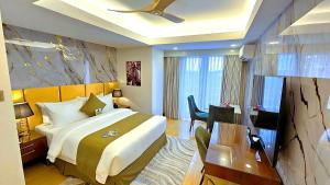 a hotel room with a large bed and a desk at Wright Park Hotel in Baguio +100 photos