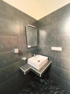 a bathroom with a sink and a mirror at Villa Mistica - Hiriketiya Dikwella in Dickwella