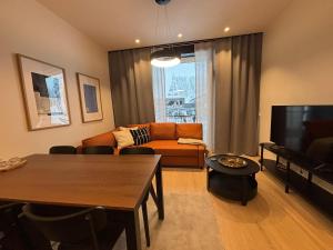 a living room with a couch and a table at Levi Fjällen 6 in Levi