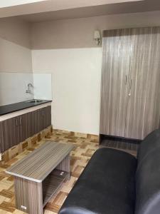a living room with a couch and a table at Zioneliteresidency in Kodaikānāl