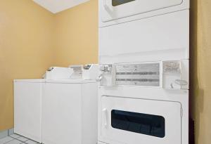 a white washer and dryer in a room at Days Inn by Wyndham East Albuquerque 'Newly Renovated' in Albuquerque