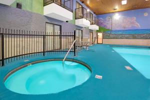 a swimming pool in a building with a blue floor at Days Inn by Wyndham East Albuquerque 'Newly Renovated' in Albuquerque