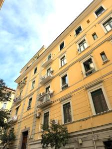 a yellow building with balconies on the side of it at Casa Boutique Mareluna - Luxury Apartments by Mareluna Hotel in Salerno