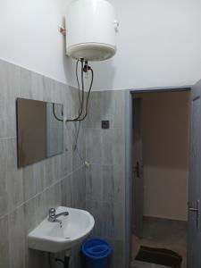 a bathroom with a sink and a mirror at Christal house in Abomey-Calavi +5 photos