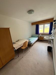 a hospital room with a bed and a sink at Hospezi Santa Maria in Platta +26 photos