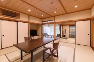 a dining room with a table and chairs at Furuya Ryokan in Atami