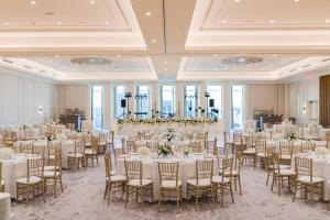 a banquet hall with tables and chairs in a room with windows at Conrad Nashville in Nashville +104 photos