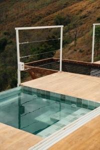 a swimming pool on the roof of a house at Cabana Greece house blue in Paty do Alferes