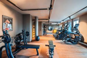 a gym with several treadmills and cardio machines at Me and All Hotel Berlin East Side, by Hyatt in Berlin