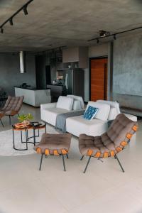 a bedroom with two beds and two chairs at Windows House in Paty do Alferes