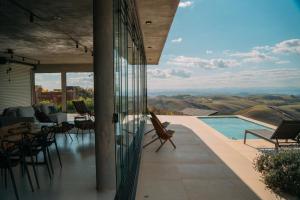 a house with a pool and a view of the mountains at Windows House in Paty do Alferes