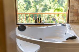 a white bath tub in front of a window at Ayung Resort Ubud in Payangan