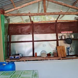 a wooden shelf in a room with a window at Nory's Tourist Inn in San Vicente
