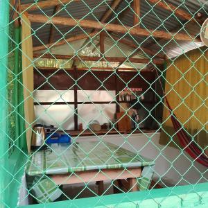 a wire cage with a table in a room at Nory's Tourist Inn in San Vicente +2 photos