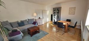 a living room with a couch and a table at Ferienwohnung Lucia Amorbach in Amorbach