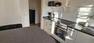 a kitchen with a counter and a stove top oven at Ferienwohnung Lucia Amorbach in Amorbach