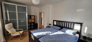 a bedroom with a bed and a chair at Ferienwohnung Lucia Amorbach in Amorbach