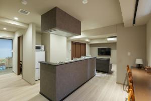 an empty kitchen with a counter in a room at A&m花畑401 in Kumamoto +13 photos