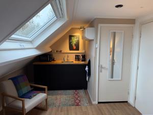 a small kitchen with a sink and a window at 't Zeeuwse licht in Middelburg