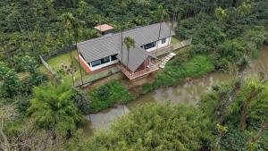 an aerial view of a house in the middle of a river at Thota'dha Tent Stay in SanivÄrsante