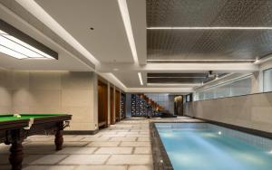 a pool in a building with a pool table at CongLinLi Wooded Homestay in Conghua