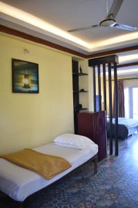 a bedroom with two beds in a room at Sea view Sun shine in Calangute