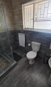 a bathroom with a toilet and a shower at 8 Austin Street Accommodation in Klerksdorp