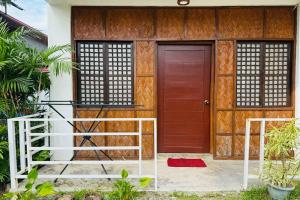 a front door of a house with a red door at Camp Saint John Hotel La Union in San Juan