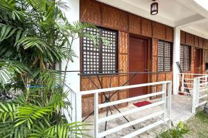 a house with a wooden door and a porch at Camp Saint John Hotel La Union in San Juan